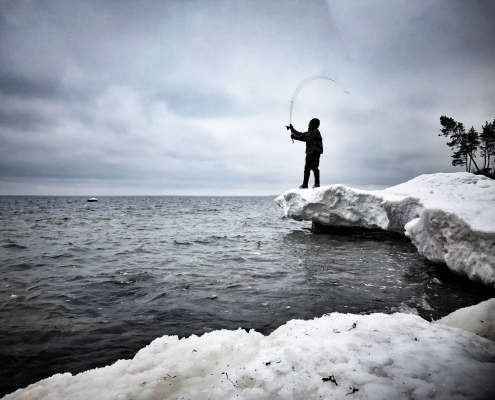 Person fishing in a snowy landscape '